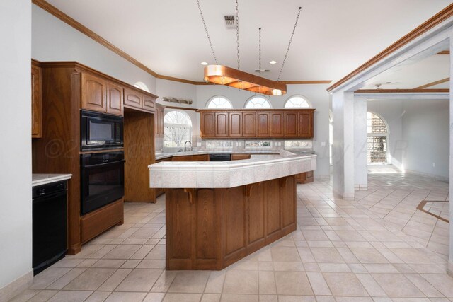121 Quail Blvd, Amarillo, TX 79124 - kitchen featuring black appliances, light countertops, ornamental molding, a kitchen island, and light tile patterned flooring