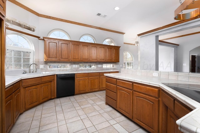 121 Quail Blvd, Amarillo, TX 79124 - kitchen with dishwasher, tasteful backsplash, brown cabinetry, crown molding, and light tile patterned flooring