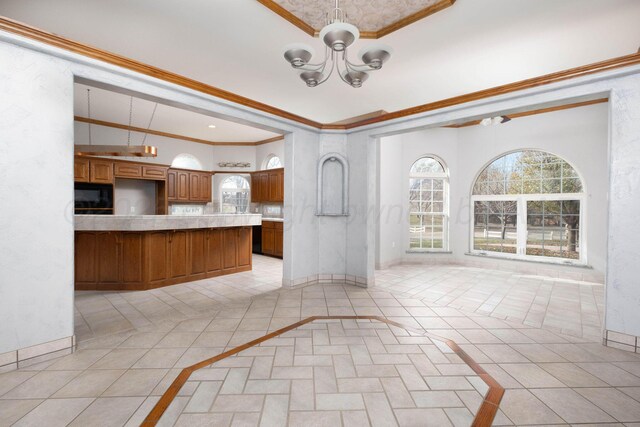 121 Quail Blvd, Amarillo, TX 79124 - kitchen featuring inlaid floor details, black microwave, ornamental molding, brown cabinets, and a chandelier
