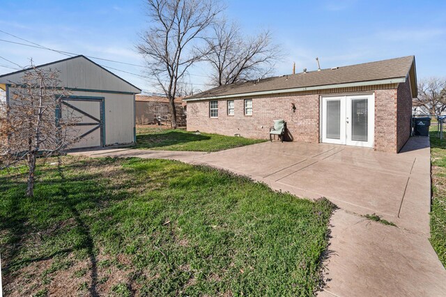 view of yard featuring an outbuilding, fence, french doors, a storage shed, and a patio area