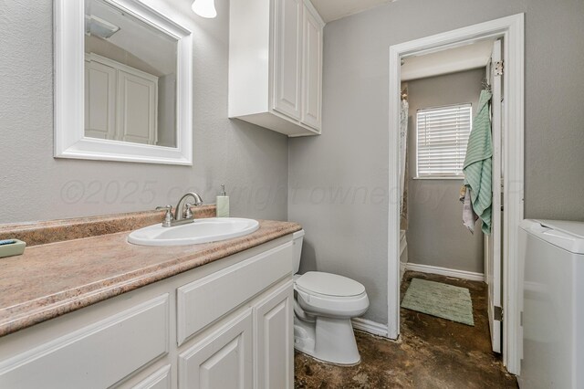 bathroom with toilet, unfinished concrete flooring, separate washer and dryer, baseboards, and vanity