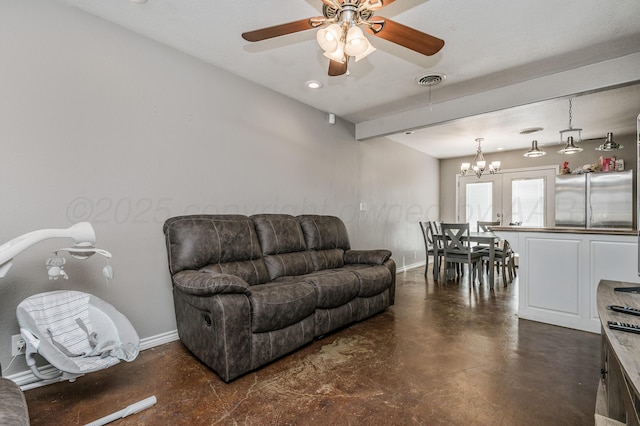 living room with visible vents, ceiling fan with notable chandelier, finished concrete flooring, and baseboards