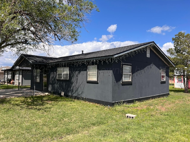 434 Long St, Hereford, TX 79045 - view of side of property with a lawn, a patio area, and roof with shingles