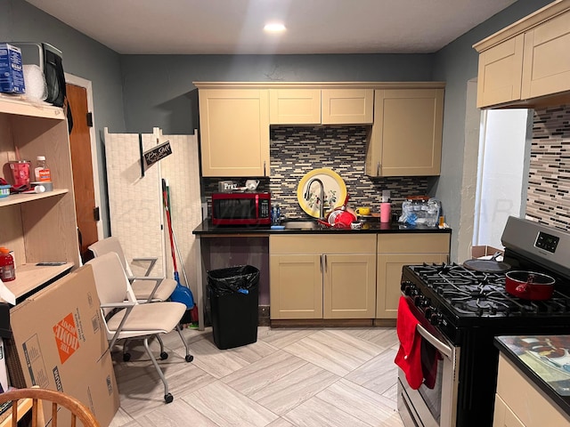 434 Long St, Hereford, TX 79045 - kitchen with stainless steel range with gas stovetop, tasteful backsplash, and dark countertops