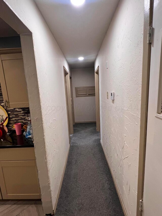 434 Long St, Hereford, TX 79045 - hallway with a textured wall, carpet flooring, and baseboards