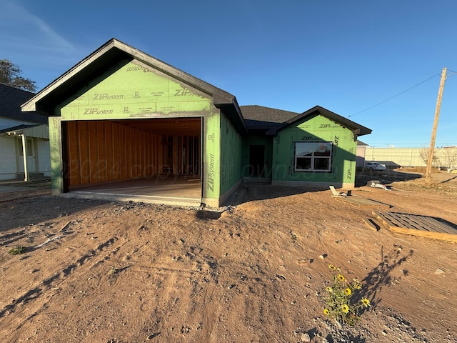 unfinished property featuring a garage