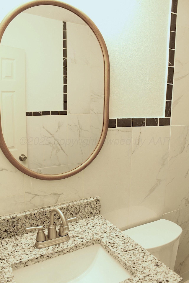 1306 N Lake St, Amarillo, TX 79107 - bathroom with toilet, tile walls, and vanity