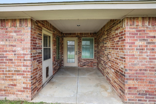 8403 Irvington Ct, Amarillo, TX 79119 - view of exterior entry with brick siding and a patio