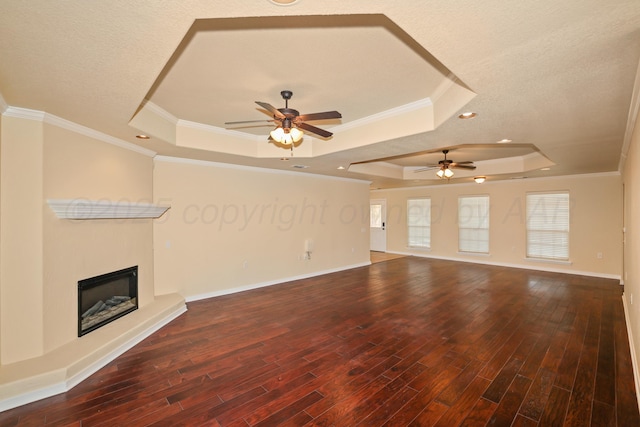 8403 Irvington Ct, Amarillo, TX 79119 - unfurnished living room with a raised ceiling, a ceiling fan, wood finished floors, a fireplace with raised hearth, and crown molding