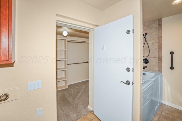 8403 Irvington Ct, Amarillo, TX 79119 - hallway featuring washing machine and dryer, baseboards, and tile patterned floors