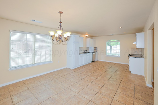 8403 Irvington Ct, Amarillo, TX 79119 - kitchen with stainless steel appliances, a chandelier, tasteful backsplash, light tile patterned flooring, and a sink