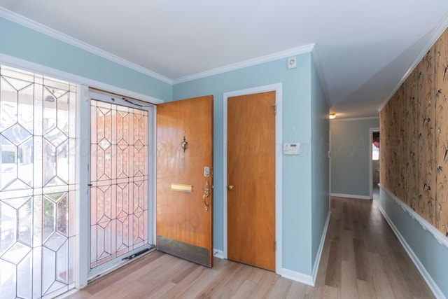 entrance foyer with baseboards, crown molding, and wood finished floors