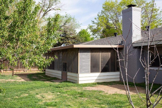 2819 Lloyd Dr, Amarillo, TX 79110 - rear view of property featuring a sunroom, a chimney, and roof with shingles