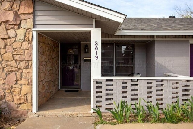 2819 Lloyd Dr, Amarillo, TX 79110 - property entrance featuring roof with shingles and stone siding