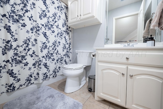 bathroom with vanity, tile patterned flooring, and toilet