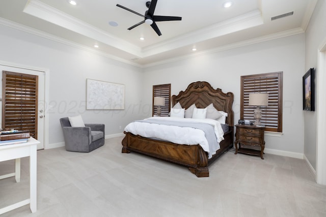 bedroom featuring crown molding, visible vents, light colored carpet, and a raised ceiling