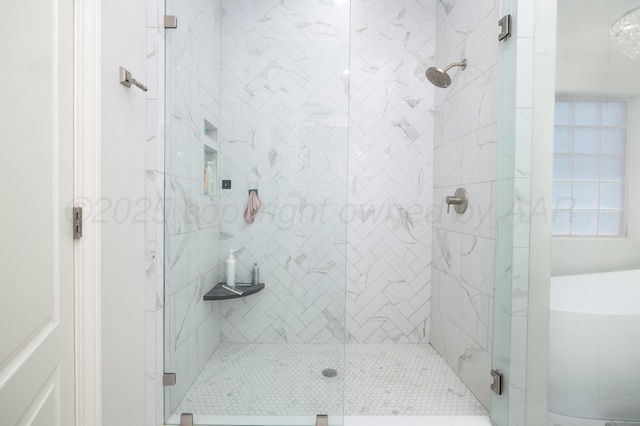 full bath with a stall shower and a soaking tub