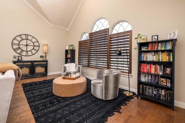 sitting room featuring crown molding, wood finished floors, and vaulted ceiling