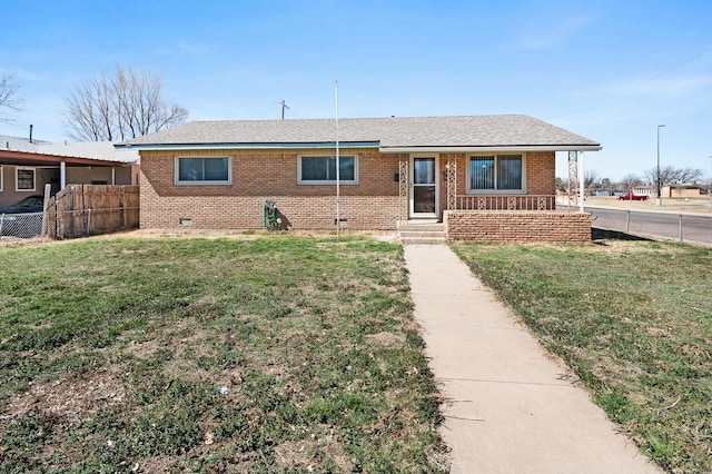 single story home featuring a front yard, fence, roof with shingles, crawl space, and brick siding