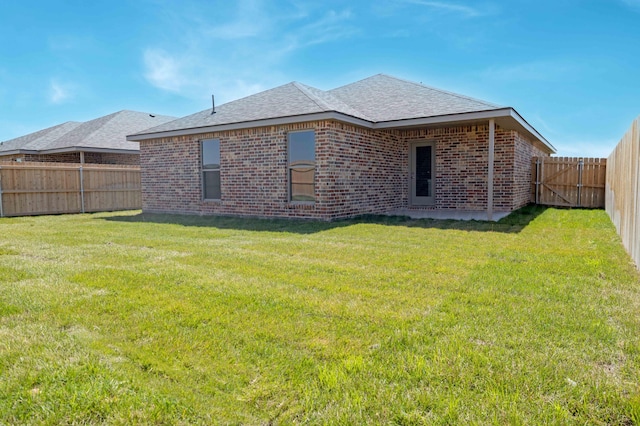10401 Ruse St, Amarillo, TX 79118 - back of property featuring brick siding, a fenced backyard, and a shingled roof