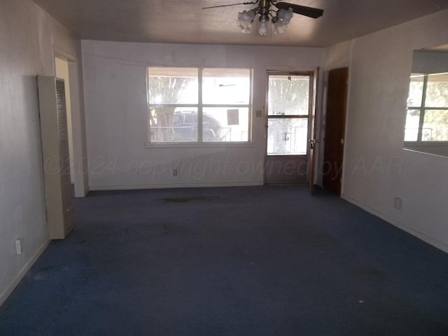 carpeted spare room featuring ceiling fan