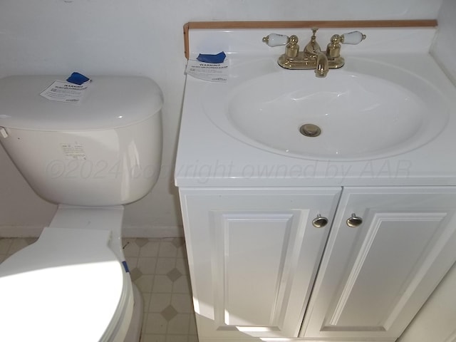 bathroom with toilet and vanity