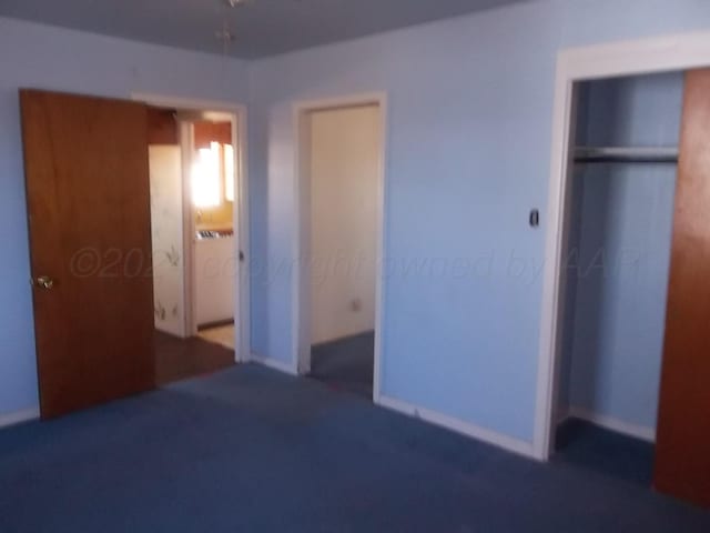 unfurnished bedroom with dark carpet