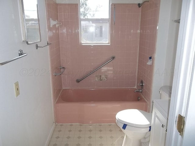 full bathroom featuring tiled shower / bath combo, vanity, a healthy amount of sunlight, and toilet