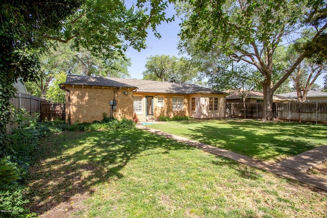 1219 S Rusk St, Amarillo, TX 79102 - back of house with brick siding and a fenced backyard