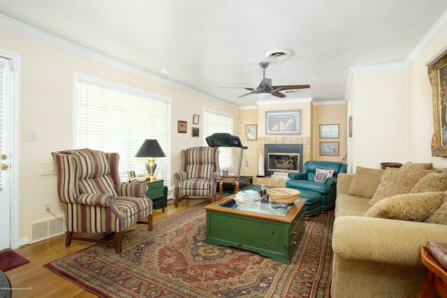 1219 S Rusk St, Amarillo, TX 79102 - living room featuring crown molding, ceiling fan, wood finished floors, healthy amount of natural light, and a fireplace