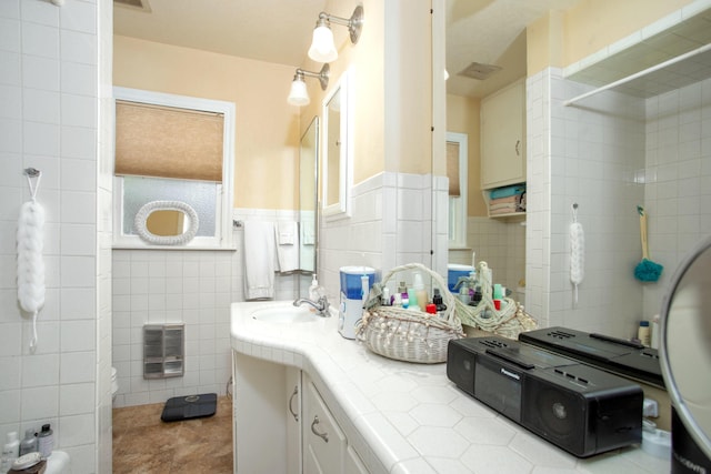 1219 S Rusk St, Amarillo, TX 79102 - bathroom featuring tile walls, vanity, a wainscoted wall, tile patterned flooring, and heating unit