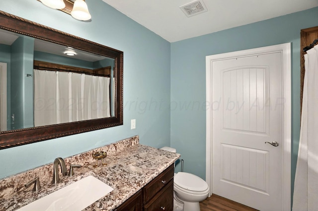 5001 Gloster St, Amarillo, TX 79118 - bathroom featuring vanity, toilet, and wood finished floors