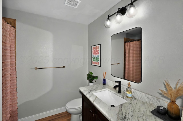 5001 Gloster St, Amarillo, TX 79118 - full bath featuring vanity, toilet, wood finished floors, and baseboards