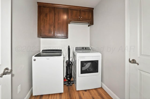 5001 Gloster St, Amarillo, TX 79118 - laundry room featuring cabinet space, washer and dryer, wood finished floors, and baseboards