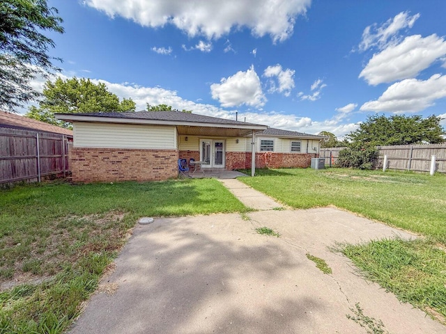 5101 Pin Oak Dr, Amarillo, TX 79110 - back of house featuring brick siding, a fenced backyard, and french doors