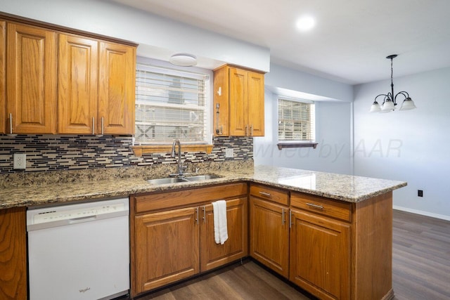 5101 Pin Oak Dr, Amarillo, TX 79110 - kitchen with white dishwasher, decorative backsplash, dark wood-style floors, a peninsula, and recessed lighting