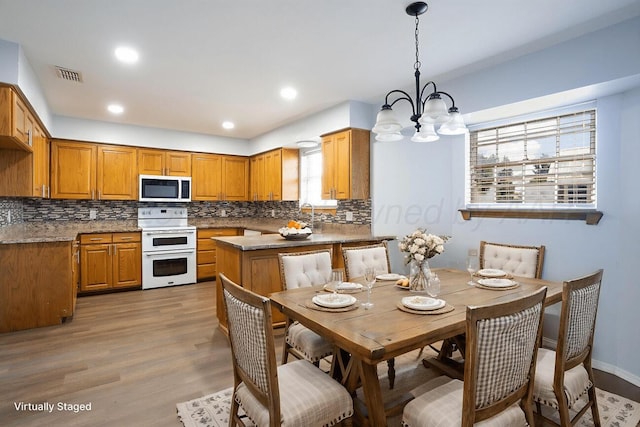 5101 Pin Oak Dr, Amarillo, TX 79110 - kitchen with range with two ovens, decorative backsplash, and plenty of natural light