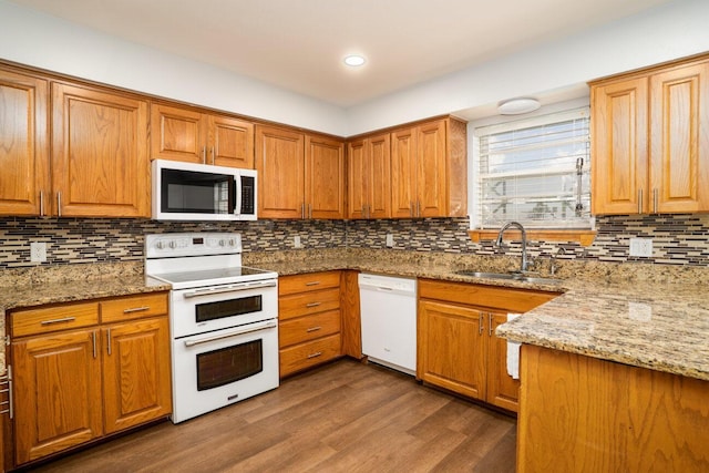 5101 Pin Oak Dr, Amarillo, TX 79110 - kitchen featuring white appliances, light stone countertops, decorative backsplash, dark wood-type flooring, and recessed lighting