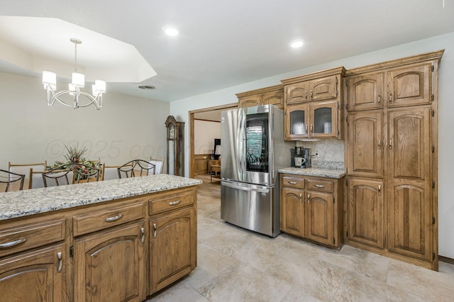 4012 Linda Dr, Amarillo, TX 79109 - kitchen with smart refrigerator, brown cabinetry, a chandelier, decorative light fixtures, and glass insert cabinets