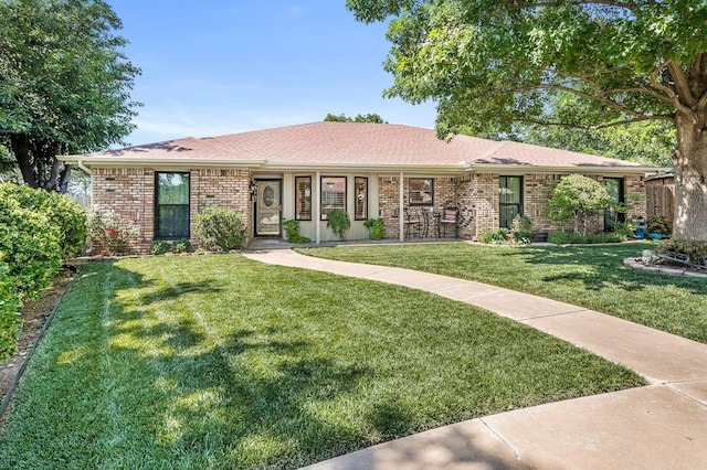 4012 Linda Dr, Amarillo, TX 79109 - ranch-style home with a front yard, brick siding, a porch, and roof with shingles