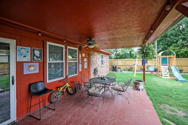7303 Jameson Dr, Amarillo, TX 79121 - fenced backyard featuring a playground, ceiling fan, and outdoor dining space
