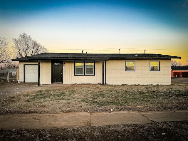 ranch-style house featuring driveway and an attached garage