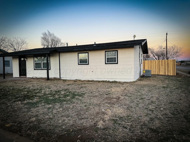 view of front of home with fence and cooling unit