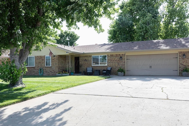 1100 Mills Ave, Dumas, TX 79029 - single story home with brick siding, a garage, concrete driveway, and a front yard
