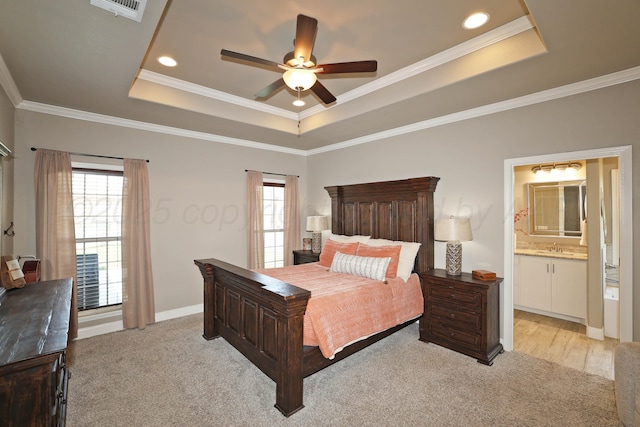 6702 Tatum Cir, Amarillo, TX 79119 - bedroom with a raised ceiling, light carpet, ornamental molding, connected bathroom, and a ceiling fan