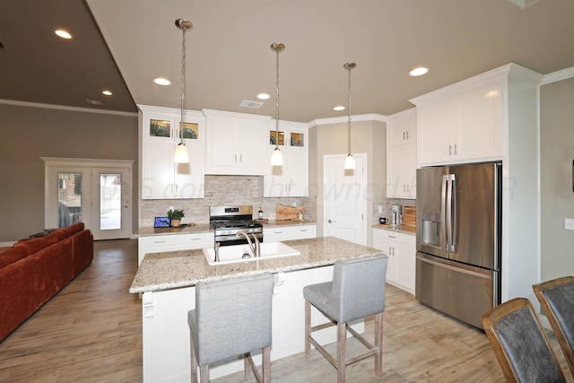 6702 Tatum Cir, Amarillo, TX 79119 - kitchen featuring stainless steel appliances, crown molding, decorative backsplash, white cabinets, and light wood-style floors