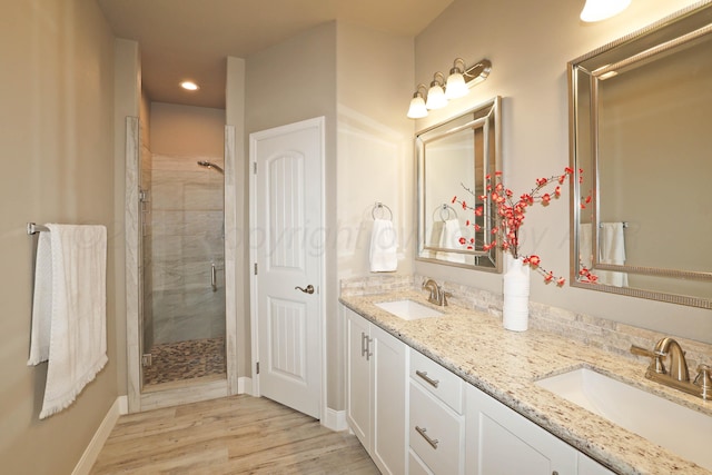 6702 Tatum Cir, Amarillo, TX 79119 - bathroom with a stall shower, double vanity, recessed lighting, and wood finished floors