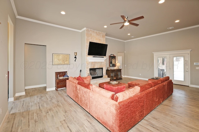 6702 Tatum Cir, Amarillo, TX 79119 - living room with ceiling fan, crown molding, light wood-style floors, recessed lighting, and a stone fireplace