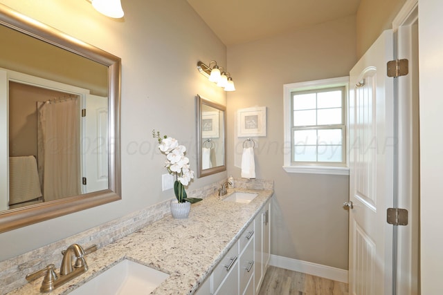 6702 Tatum Cir, Amarillo, TX 79119 - full bathroom with double vanity and wood finished floors