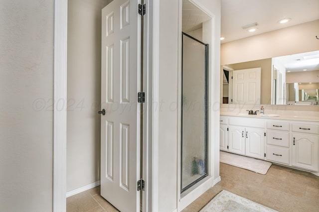 bathroom featuring tile patterned floors, vanity, and walk in shower